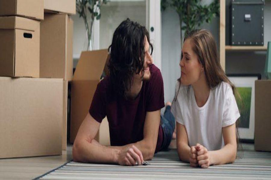 a couple talking about brain teasers to play while settling into a new home